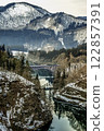 A train going over a bridge over the Tadami River 122857391