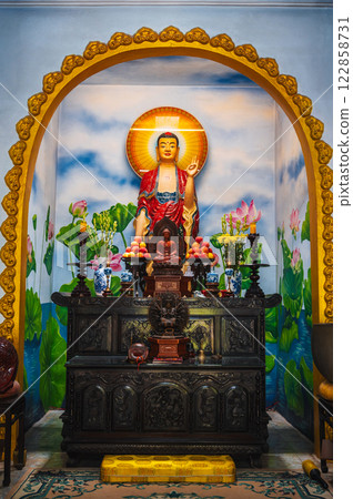 An altar with a Buddha in a pagoda on the marble mountains of Da Nang. 122858731