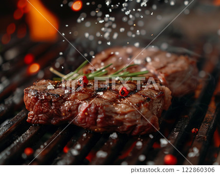 Close-up Slice juicy beef lamb rib steak meat grilled on heat hot roasted flame cooking meal, lunch dinner coal fire smoke with salt and pepper spice beefsteak for party picnic outdoor refreshment 122860306