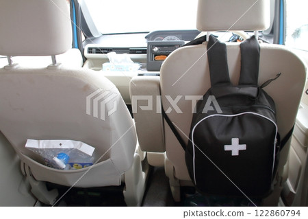 Emergency backpack hanging on the back of a car seat 122860794