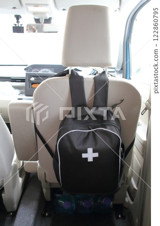 Emergency backpack hanging on the back of a car seat Emergency backpack hanging on the back of a car seat 122860795