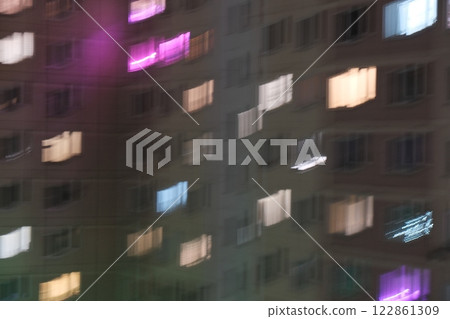 Blurred city lights at night, simulating vision with astigmatism. Abstract urban atmosphere with glowing bokeh effec Blurred city lights at night, simulating vision with astigmatism. Abstract urban atmosphere with glowing bokeh effec 122861309