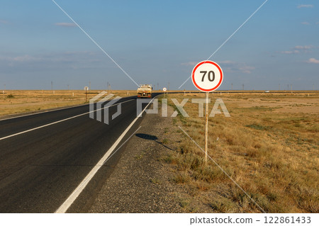 Speed limit sign indicating 70 km on rural road in Atyrau Region Kazakhstan 122861433