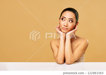 Beautiful smiling woman portrait looking aside on copy space Beautiful smiling woman portrait looking aside on copy space 122861563