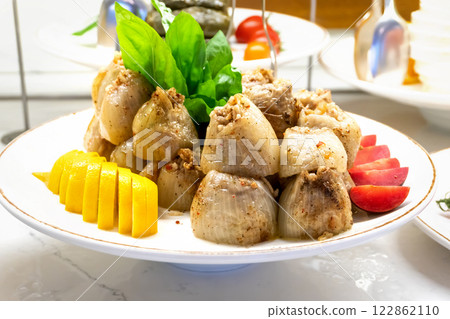 Turkish Stuffed Onions with Herbs, Lemon, and Cherry Tomatoes 122862110