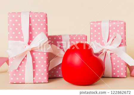 gift box with red bow and red heart on colored background. Perspective view. Flat lay 122862672