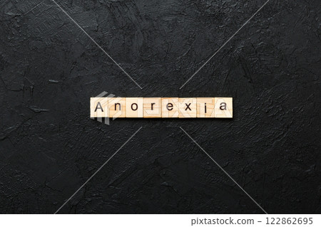 anorexia word written on wood block. anorexia text on table, concept anorexia word written on wood block. anorexia text on table, concept 122862695