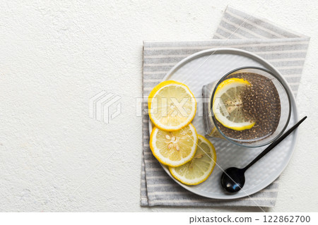 Healthy breakfast or morning with chia seeds and lemon on table background, vegetarian food, diet and health concept. Chia pudding with lemon Healthy breakfast or morning with chia seeds and lemon on table background, vegetarian food, diet and health concept. Chia pudding with lemon 122862700