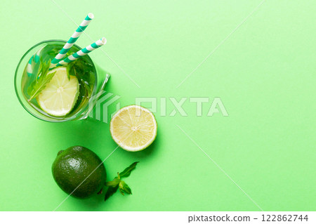 Caipirinha, Mojito cocktail, vodka or soda drink with lime, mint and straw on table background. Refreshing beverage with mint and lime in glass top view flat lay 122862744