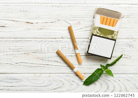 Pack of menthol cigarettes and fresh mint on colored table, Menthol cigarettes top view flat lay 122862745