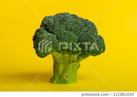 Top view fresh green broccoli vegetable on Colored background. Broccoli cabbage head Healthy or vegetarian food concept. Flat lay. Copy space 122862830