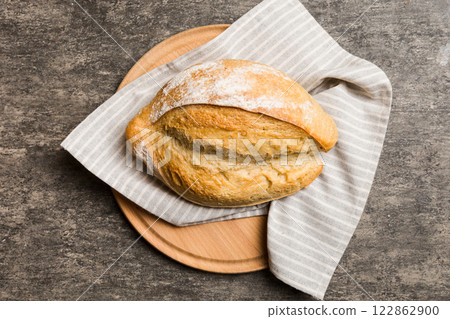 Freshly baked bread on cutting board against white wooden background. top view bread with copy space Freshly baked bread on cutting board against white wooden background. top view bread with copy space 122862900