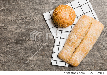 Assortment of freshly baked bread with napkin on rustic table top view. Healthy unleavened bread. French bread 122862901