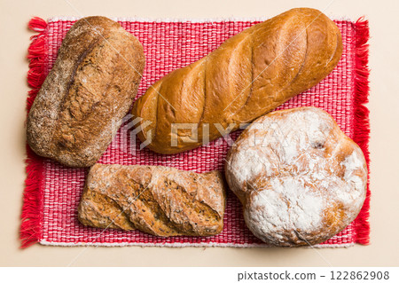 Assortment of freshly baked bread with napkin on rustic table top view. Healthy unleavened bread. French bread 122862908