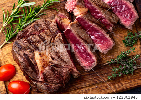 Ribeye grilled beef steak sliced . Rare doneness photography . Top view Ribeye grilled beef steak sliced . Rare doneness photography . Top view 122862943
