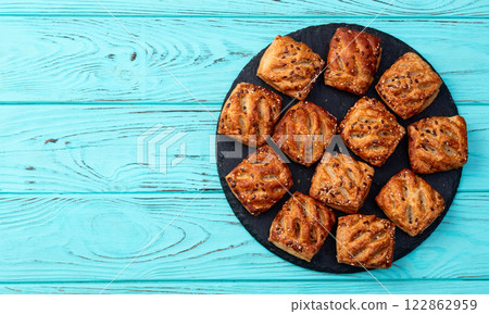 Flaky Pastries with Sesame Seeds on Slate 122862959