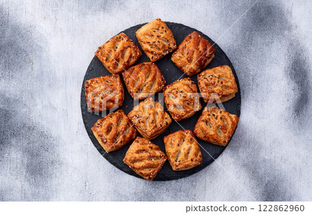 Flaky Pastries with Sesame Seeds on Slate 122862960