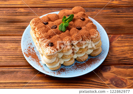 Classic Tiramisu Dessert on Rustic Plate 122862977