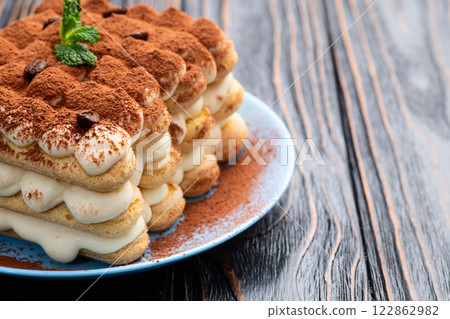 Classic Tiramisu Dessert on Rustic Plate Classic Tiramisu Dessert on Rustic Plate 122862982
