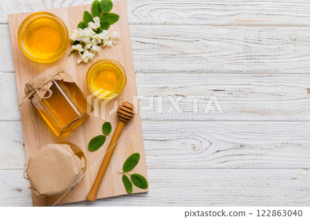 honey jar with acacia flowers and leaves. fresh honey top view flat lay 122863040