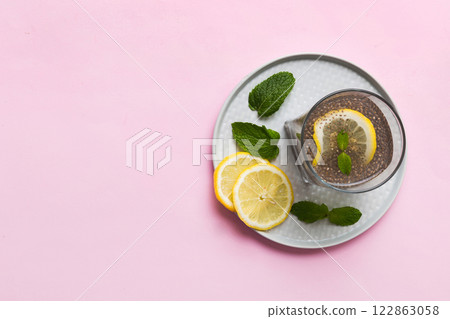 Healthy breakfast or morning with chia seeds lemon and mint on table background, vegetarian food, diet and health concept. Chia pudding with lemon and mint 122863058