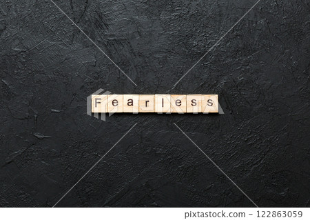 Fearless word written on wood block. Fearless text on cement table for your desing, concept Fearless word written on wood block. Fearless text on cement table for your desing, concept 122863059