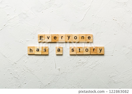 Everyone Has a Story word written on wood block. Everyone Has a Story text on cement table for your desing, concept 122863082