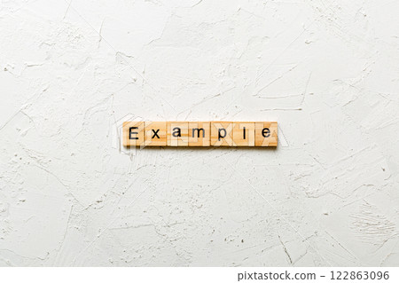 example word written on wood block. example text on table, concept 122863096