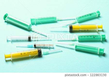 Top view of different syringes at blue background. Medical injection concept with copy space 122863130