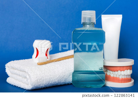 Mouthwash and other oral hygiene products on colored table top view with copy space. Flat lay. Dental hygiene. Oral care kit. Dentist concept Mouthwash and other oral hygiene products on colored table top view with copy space. Flat lay. Dental hygiene. Oral care kit. Dentist concept 122863141