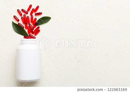 different drugs and health supplement pills poured from a medicine bottle health care and medical top view on colored background different drugs and health supplement pills poured from a medicine bottle health care and medical top view on colored background 122863169
