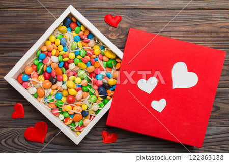 Valentine day composition: sweet candy, with gift boxes with bow and red felt hearts, photo template, background. Top View with copy space 122863188