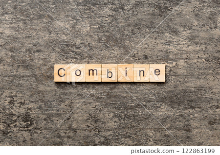 COMBINE word written on wood block. COMBINE text on cement table for your desing, concept 122863199