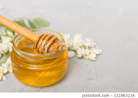 robinia honey bollte with acacia blossoms on colored table robinia honey bollte with acacia blossoms on colored table 122863216