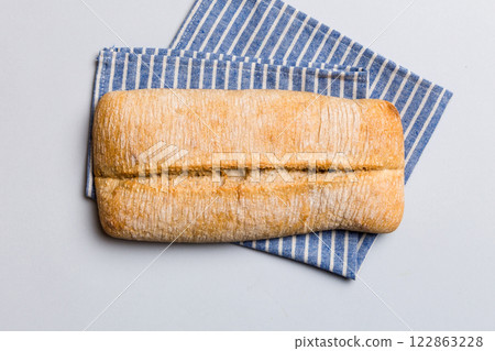 Fresh ciabatta bread on napkin on rustic background, Italian bread top view 122863228