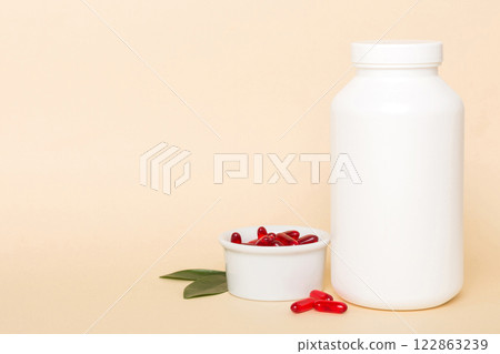different drugs and health supplement pills with medicine bottle health care and medical top view. Vitamin tablets. Bottle with colored pills on table background. Multivitamins 122863239