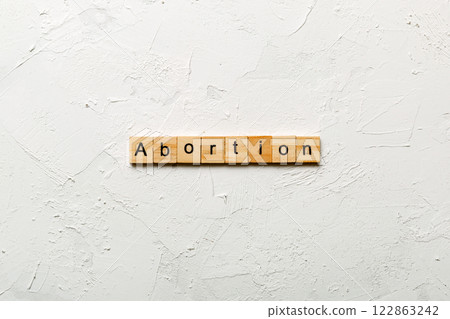 abortion word written on wood block. abortion text on table, concept 122863242