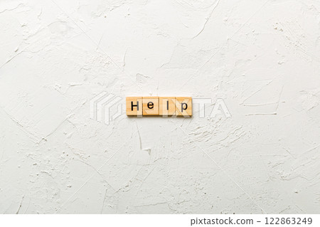 Help word written on wood block. Help text on table, concept Help word written on wood block. Help text on table, concept 122863249