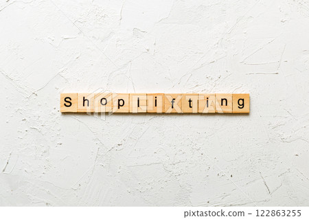 Shoplifting word written on wood block. Shoplifting text on cement table for your desing, Top view concept 122863255