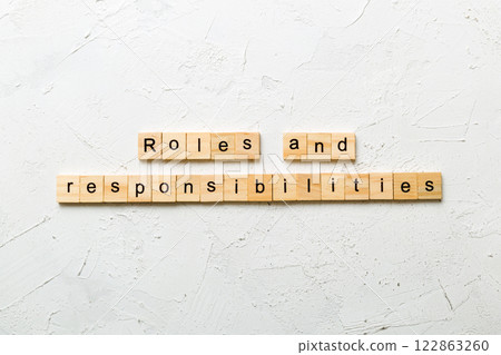 roles and responsibilities word written on wood block. roles and responsibilities text on table, concept roles and responsibilities word written on wood block. roles and responsibilities text on table, concept 122863260