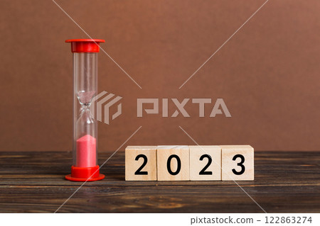 New Year 2023 sand timer. Resolution, time, plan, goal, motivation, reboot, countdown and New Year holiday concepts. Hourglass with number 2023 122863274