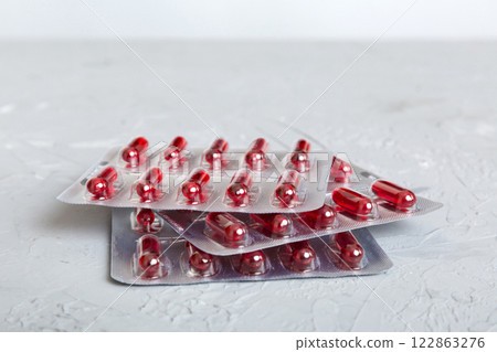 too many different pill cartridges stacked. selective Focus. Packs of blister pills with tablets. Colored pastilles packages. A pile of medicine in blister packs. Pharmaceutical blister packs 122863276