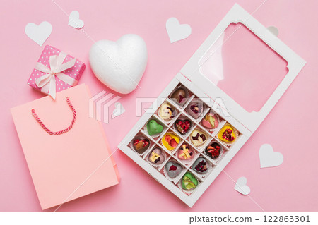 Valentine day composition: sweet candy, with gift boxes with bow and red felt hearts, photo template, background. Top View with copy space 122863301