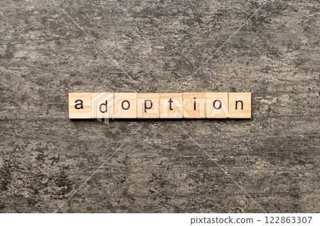 adoption word written on wood block. adoption text on table, concept adoption word written on wood block. adoption text on table, concept 122863307