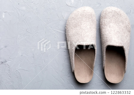 Warm winter women woolen slippers on the floor. Copy space for text 122863332