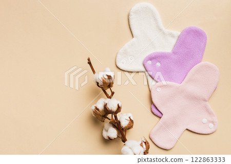 set of colorful bright reusable menstrual pads with cotton flower. zero waste woman periods concept top view with copy space set of colorful bright reusable menstrual pads with cotton flower. zero waste woman periods concept top view with copy space 122863333