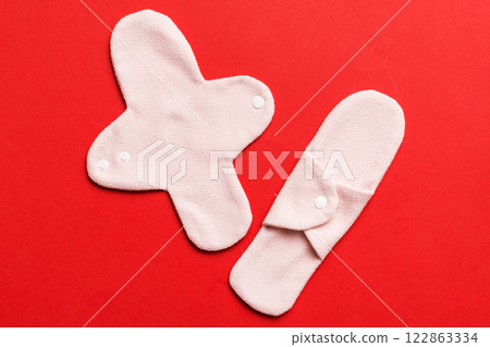 Eco-friendly reusable fabric women's pads. set of colorful bright reusable menstrual pads. zero waste woman periods concept top view with copy space Eco-friendly reusable fabric women's pads. set of colorful bright reusable menstrual pads. zero waste woman periods concept top view with copy space 122863334