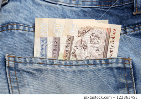 Belizean dollar in the pocket of blue jeans Belizean dollar in the pocket of blue jeans 122863455