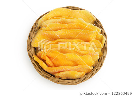 dried mango in a wicker basket isolated on white background. Top view. Flat lay. 122863499