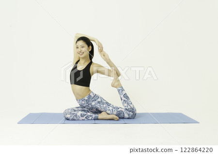 Young woman doing pigeon pose yoga on white background Young woman doing pigeon pose yoga on white background 122864220